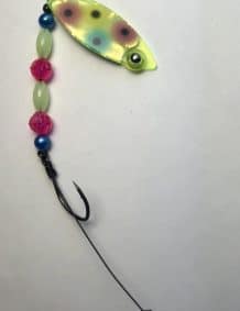 Brightly colored fishing lure with beads and hook for freshwater fishing.