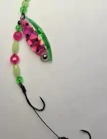 Colored fishing lure with beads and hook for premium tackle.