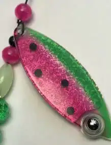 Colored fishing lure with double blades and gold backing.