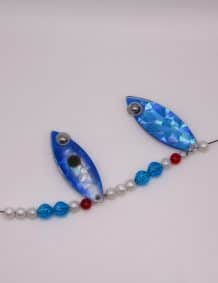 Blue fishing lure with beads and pearls for freshwater and saltwater fishing.
