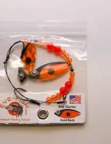 Fishing lure with beads and swivel for bass fishing, packaged in clear plastic for easy display.