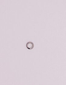 Up of a fishing tackle ring on a plain background.