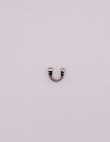 Small metal fishing hook component on a plain background.