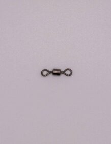 Small fishing tackle swivel on light background for fishing gear.