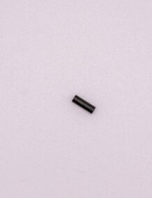 Up of a small fishing tackle component on a light background.