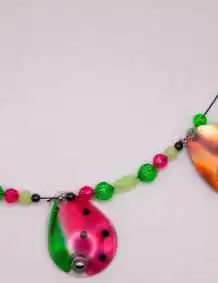 Colorful fishing tackle accessories with beads and fish-shaped lures for fishing enthusiasts.