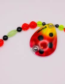 Brightly colored fishing lure with beads and blade for freshwater fishing.
