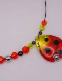 Brightly colored fishing tackle with beads and a ladybug lure for freshwater fishing.
