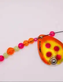 Bright fishing lure with beads and spinner for freshwater fishing.