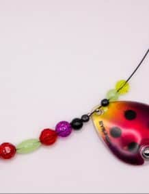 Brightly colored fishing lure with beads and ladybug pattern for freshwater fishing.