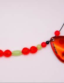 Fishing lure with beads and a red sinker, ideal for freshwater and saltwater fishing.