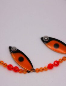 Fishing lure with orange and black design, beads, and hook for freshwater and saltwater fishing.